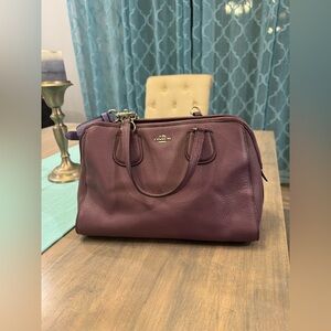 Purple COACH  purse with light purple shoulder strap.